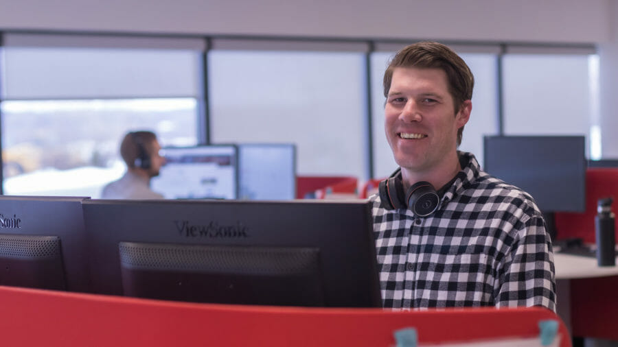 BDR employee at desk with headset